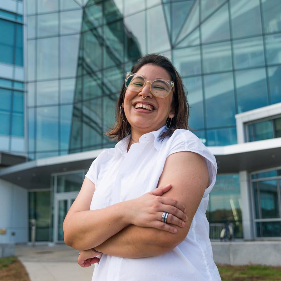 Female student smiling with arms crossed